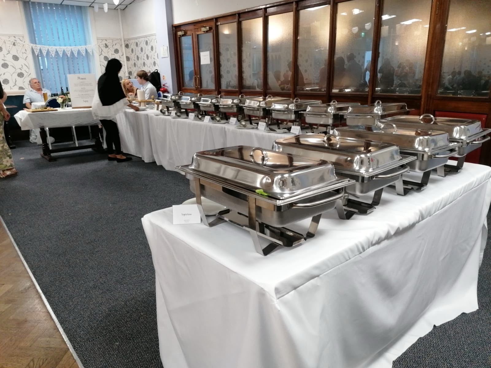 Buffet line with covered chafing units ready for service